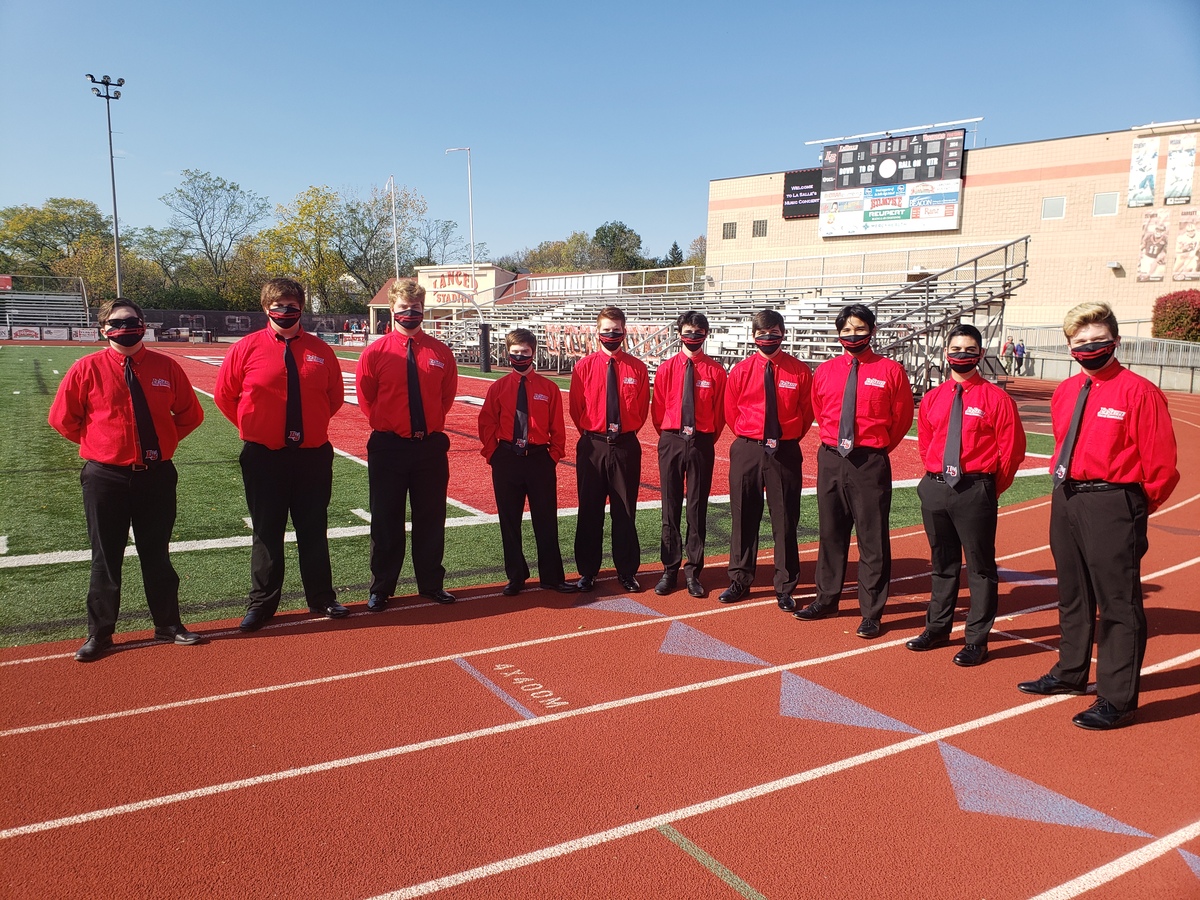 VE singers in their uniforms on the track